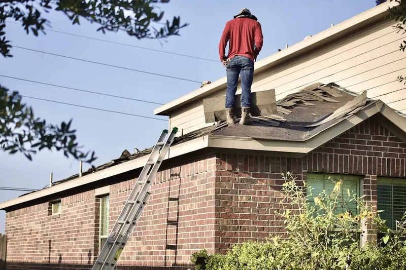 Professional roofer working on a residential roof in The Wyndon